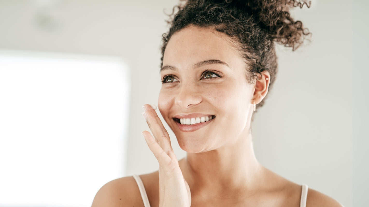 Woman applying product to face