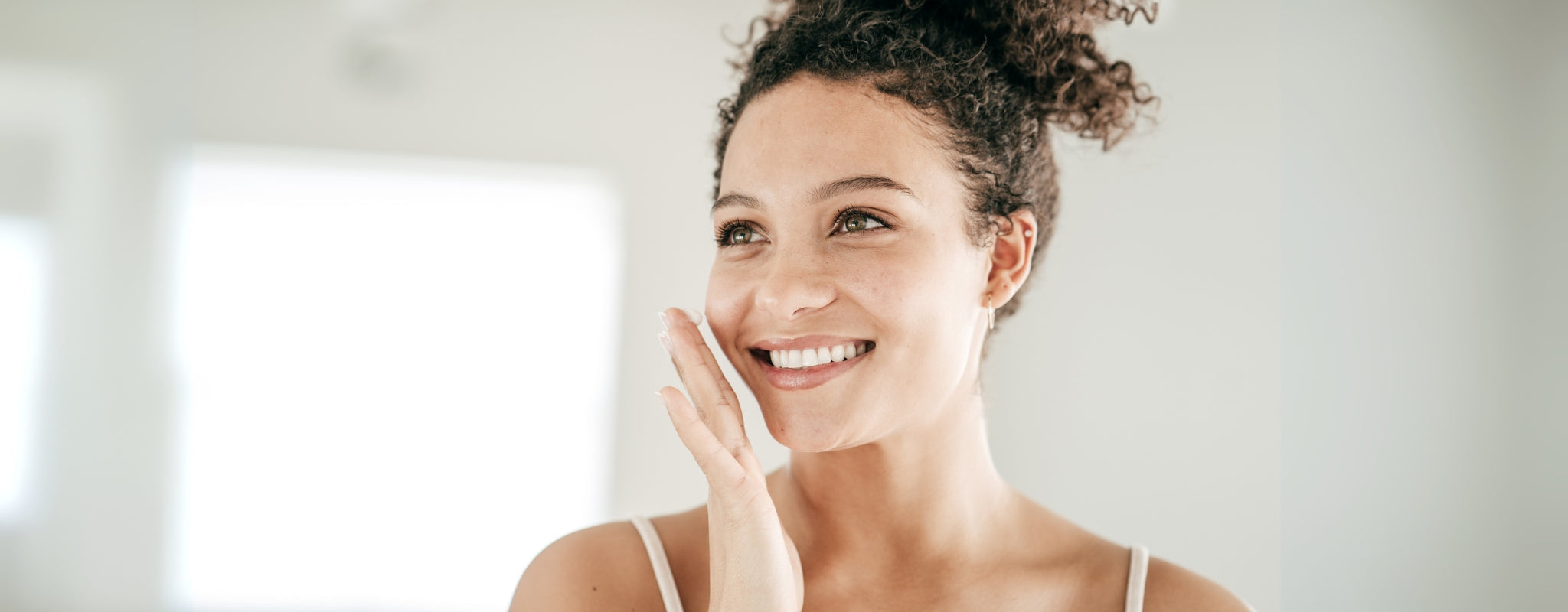 Woman applying product to face